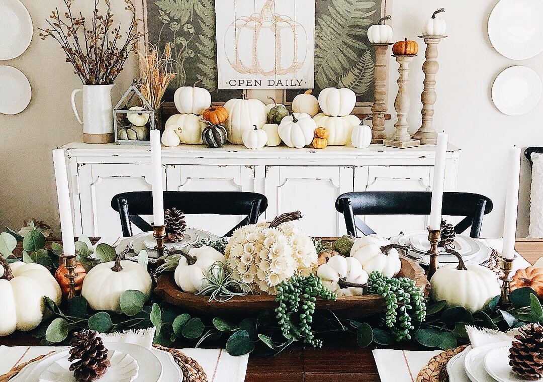 dining room table decorated for fall with pumpkins