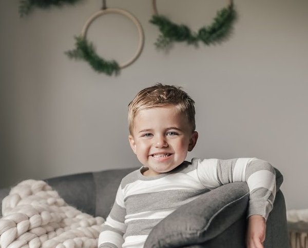 Child smiling in room.