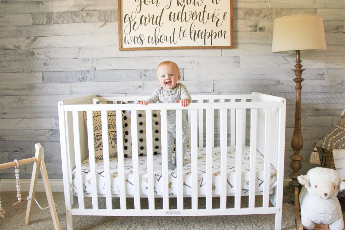 Oliver standing in crib.