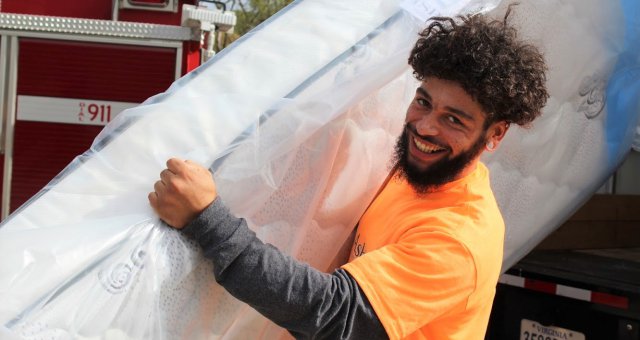 Ashley employee with mattress.