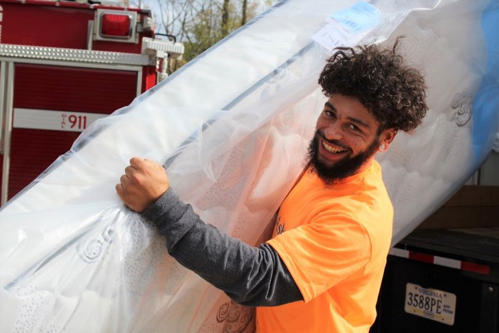 Ashley employee with mattress.